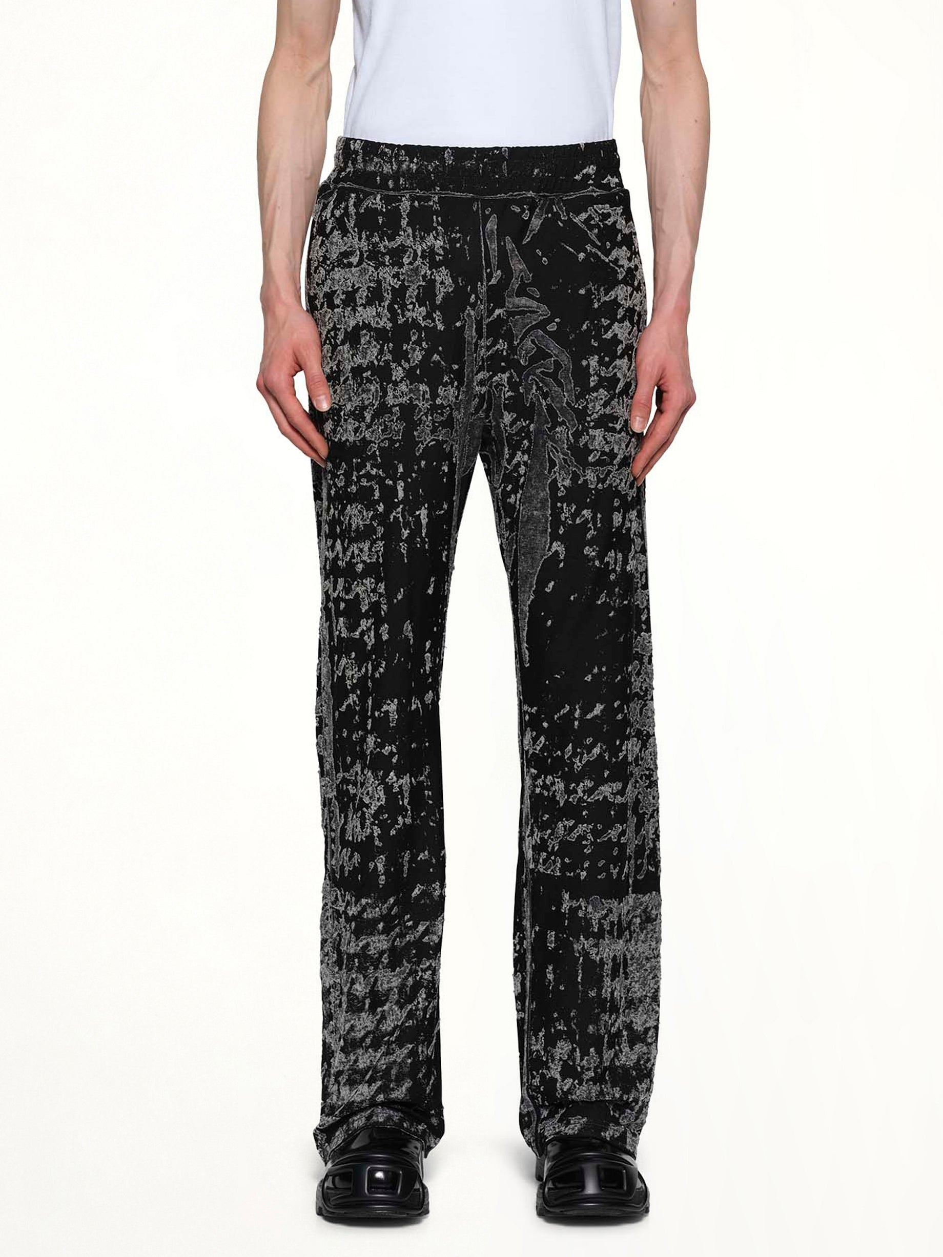 Image of a model wearing Pants. Productname: DIESEL P-CORR Track Pants in Black colour by brand - DIESEL