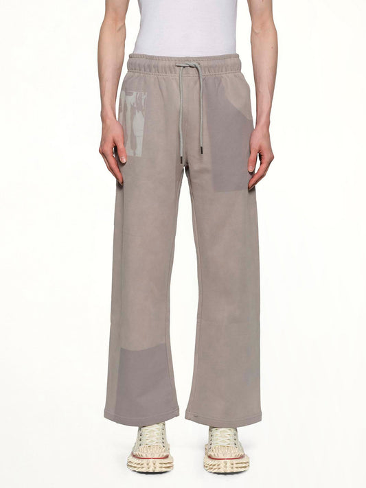Image of a model wearing Pants. Productname: KID SUPER Sun Faded Sweatpants in Grey colour by brand - KID SUPER