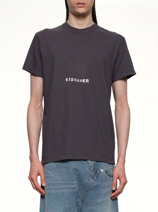 Image of a model wearing Tops. Productname: KID SUPER KID SUPER Logo T-Shirt in Black colour by brand - KID SUPER