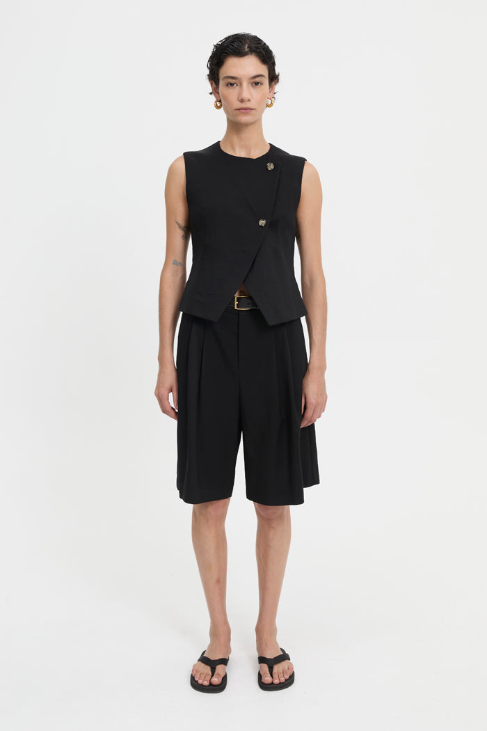Image of a model wearing Tops. Product name - Junia Vest Black in Black colour by brand - Blanca Studio
