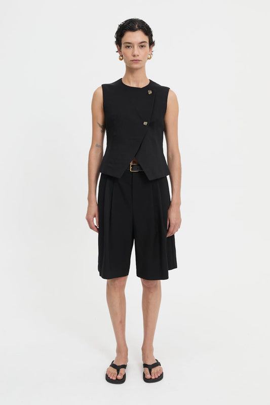Image of a model wearing Tops. Product name - Junia Vest Black in Black colour by brand - Blanca Studio