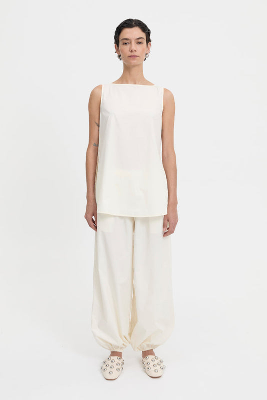 Image of a model wearing Pants. Product name - Yan Pants Cream in Cream colour by brand - Blanca Studio