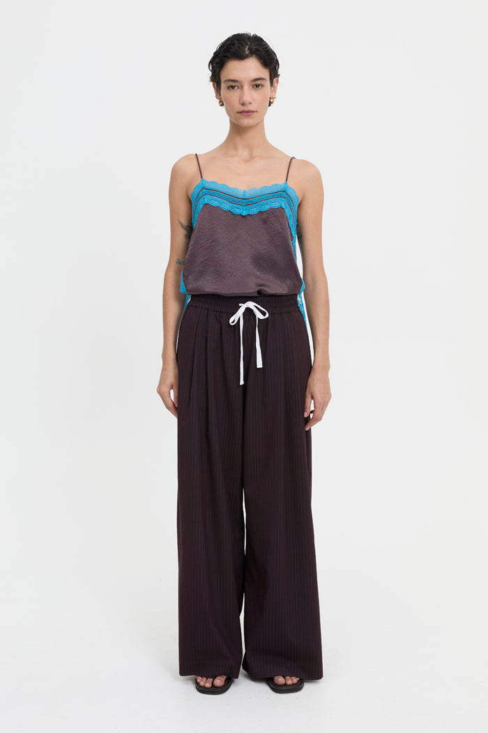 Image of a model wearing Pants. Product name - Mavis Trousers Brown in Brown colour by brand - Blanca Studio