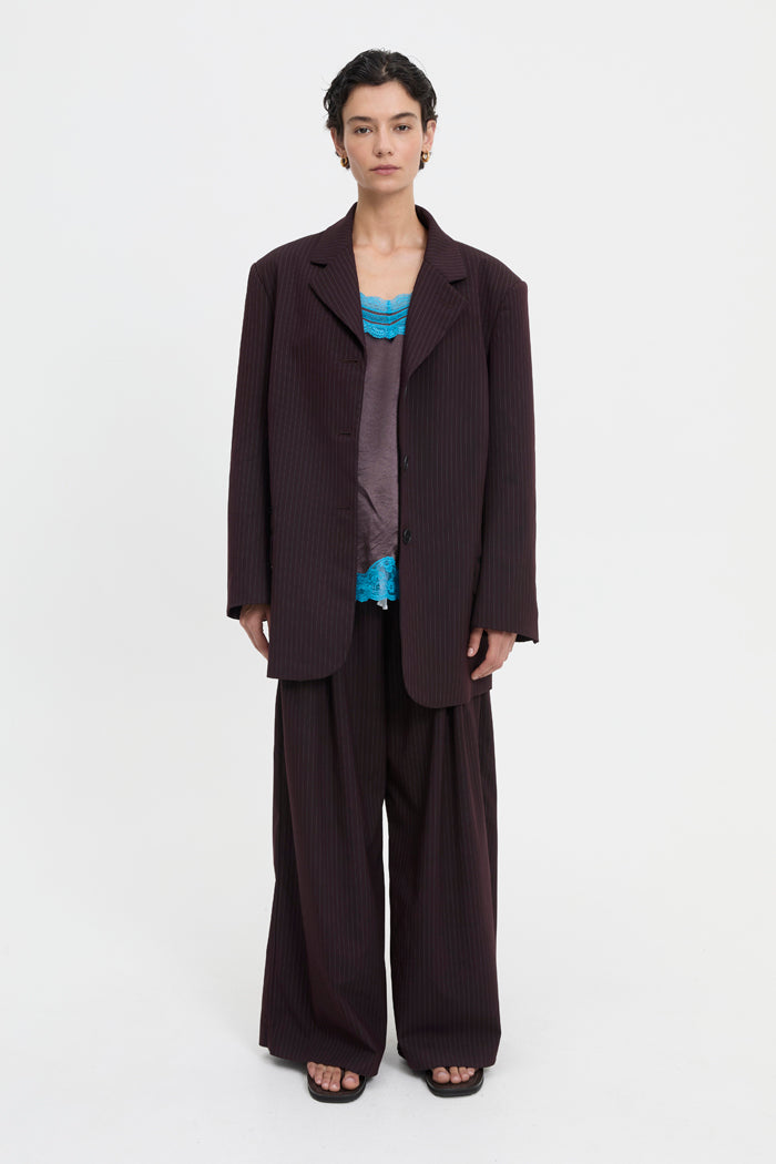 Image of a model wearing Outerwear. Product name - Mavis Blazer Brown in Brown colour by brand - Blanca Studio