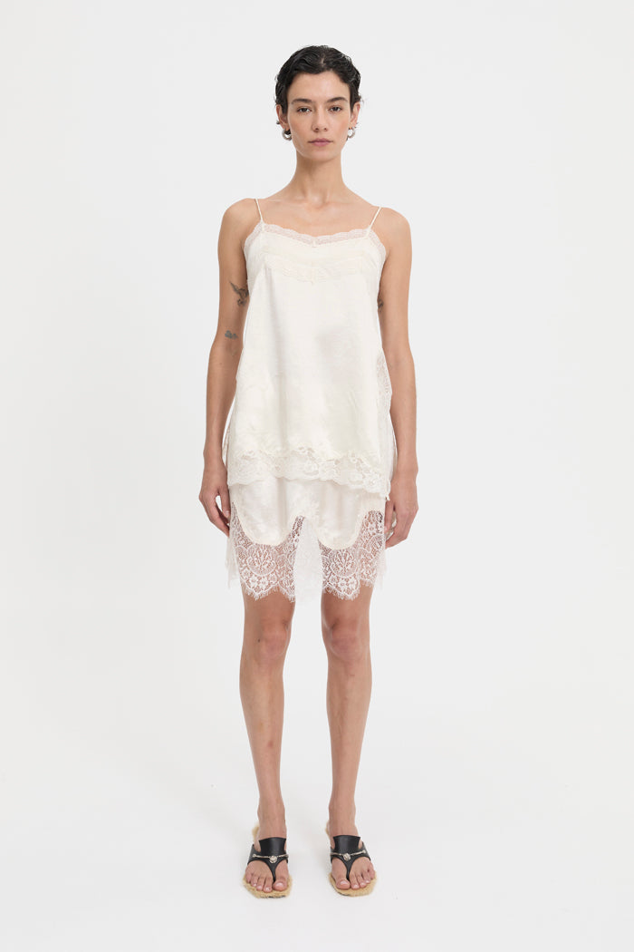 Image of a model wearing Tops. Product name - Lily Top Cream in Cream colour by brand - Blanca Studio