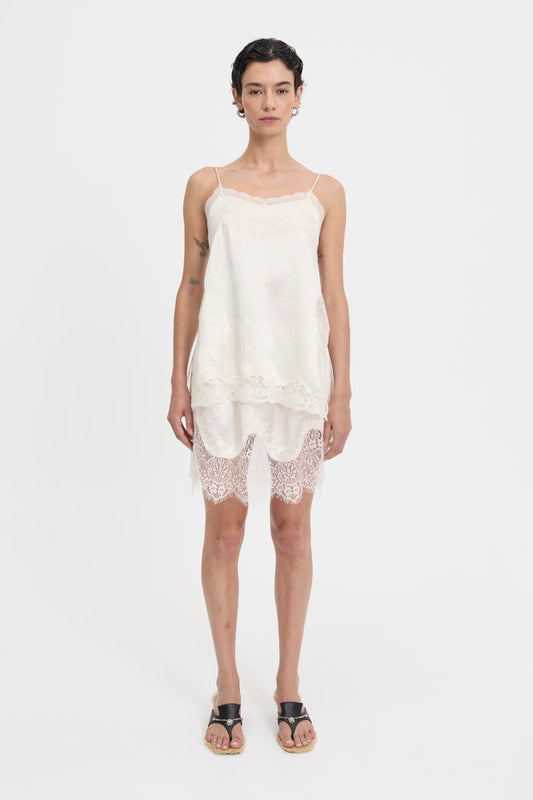 Image of a model wearing Tops. Product name - Lily Top Cream in Cream colour by brand - Blanca Studio