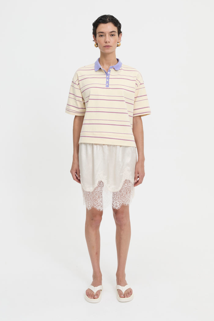 Image of a model wearing Tops. Product name - Natalini Polo Cream in Cream colour by brand - Blanca Studio