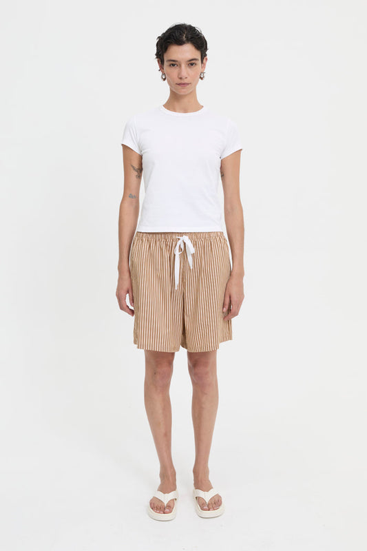Image of a model wearing Shorts. Product name - Nate Shorts Brown in Brown colour by brand - Blanca Studio