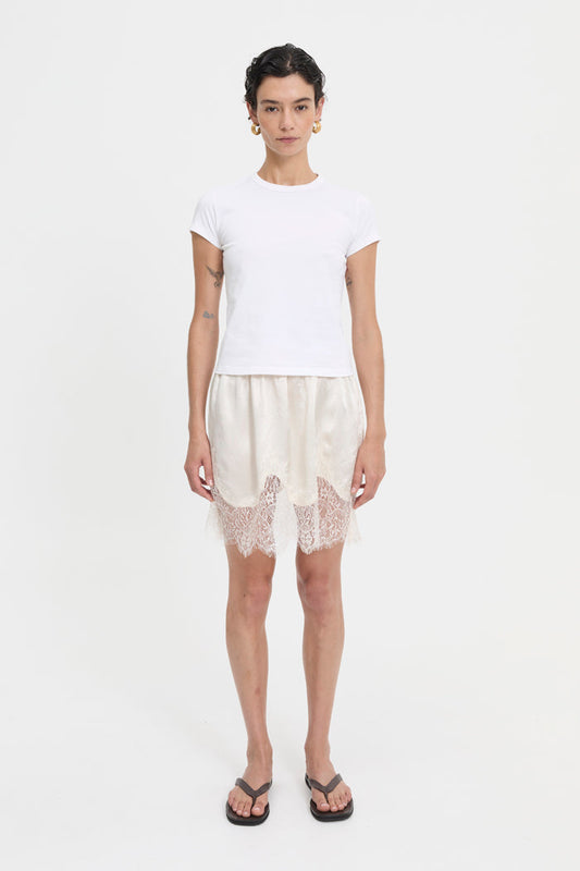Image of a model wearing Skirts. Product name - Lily Skirt Cream in Cream colour by brand - Blanca Studio