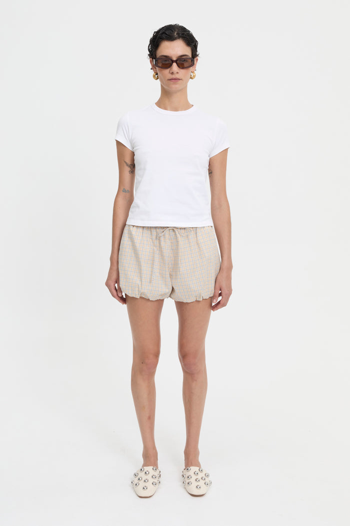 Image of a model wearing Shorts. Product name - Isley Shorts Cream in Cream colour by brand - Blanca Studio
