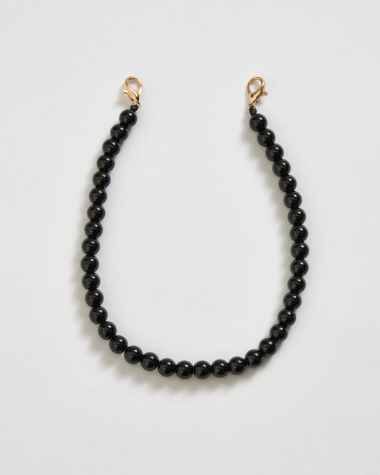 Image of Keychains. Product name - Mauritius Phone Charm Black in colour by brand - Reliquia Jewellery