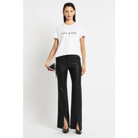 Image of a model wearing Tops. Productname: The Classics Tee in IVORY/BLACK LOGO colour by brand - sass and bide