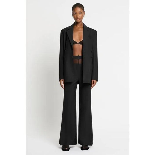 Image of a model wearing Outerwear. Productname: Kick The Tragedy Blazer in Black colour by brand - sass and bide
