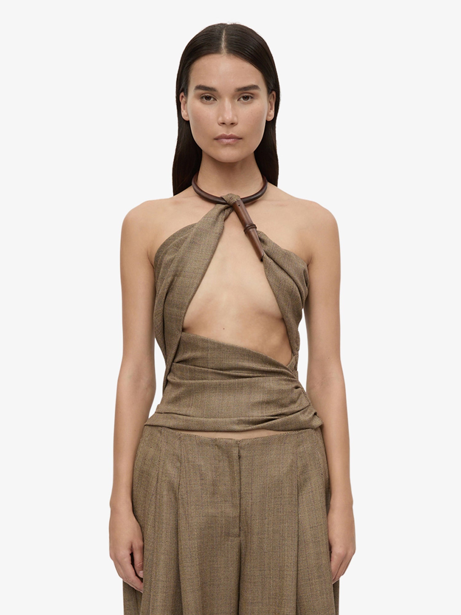 Image of a model wearing Tops. Product name - Chime Necklace Herringbone Halter Top in Brown colour by brand - CHRISTOPHER ESBER