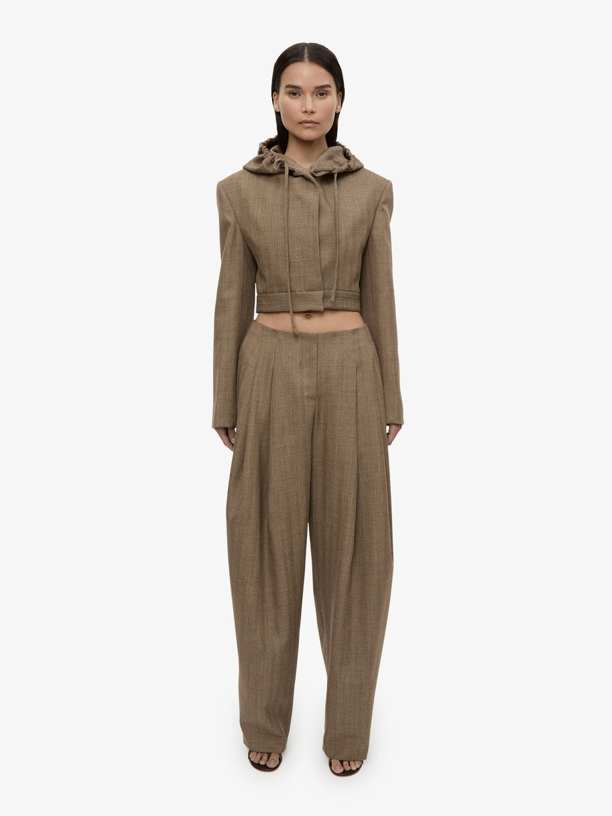 Image of a model wearing Pants. Product name - Plinth Herringbone Trouser in Brown colour by brand - CHRISTOPHER ESBER