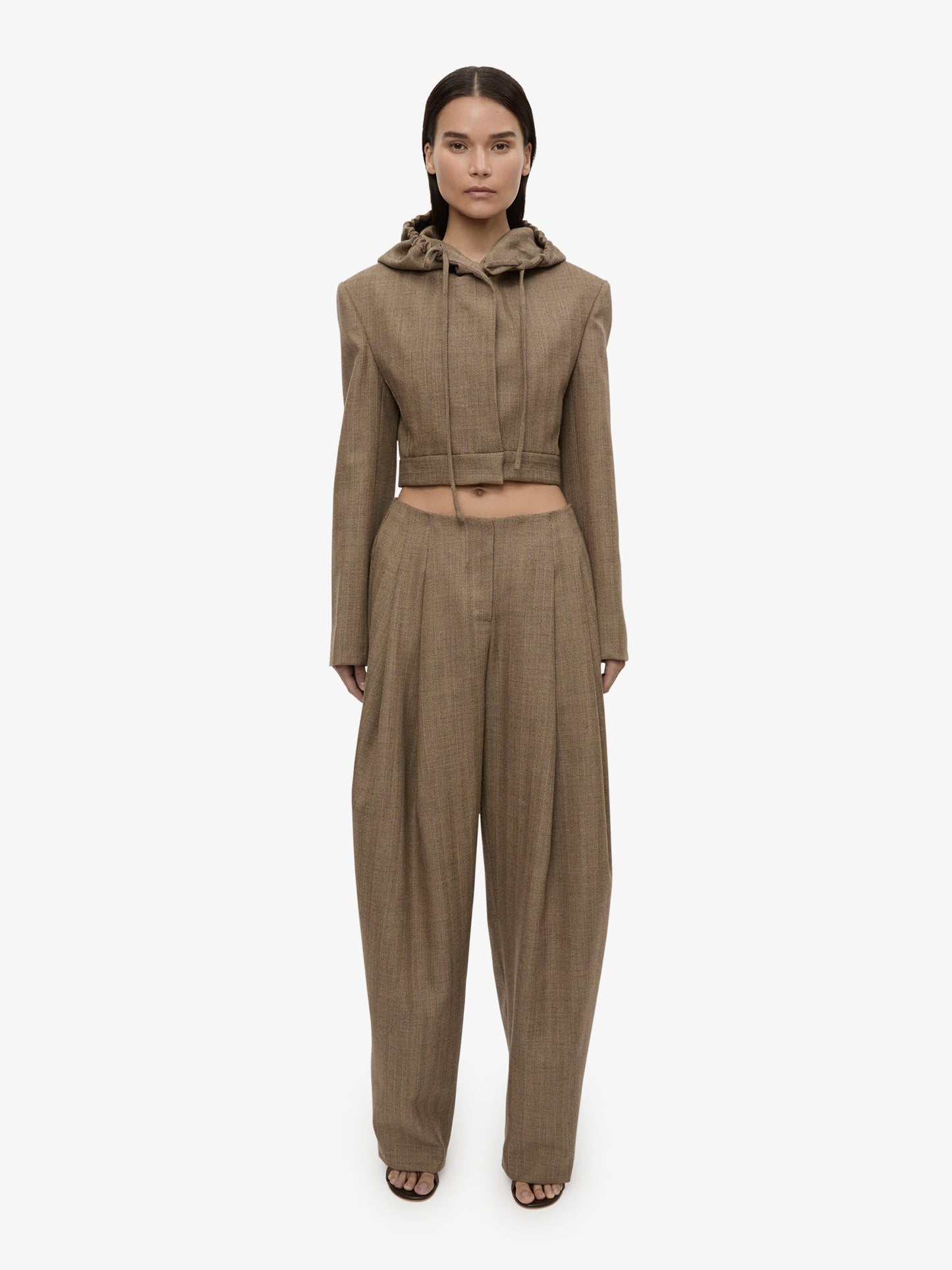 Image of a model wearing Pants. Product name - Plinth Herringbone Trouser in Brown colour by brand - CHRISTOPHER ESBER