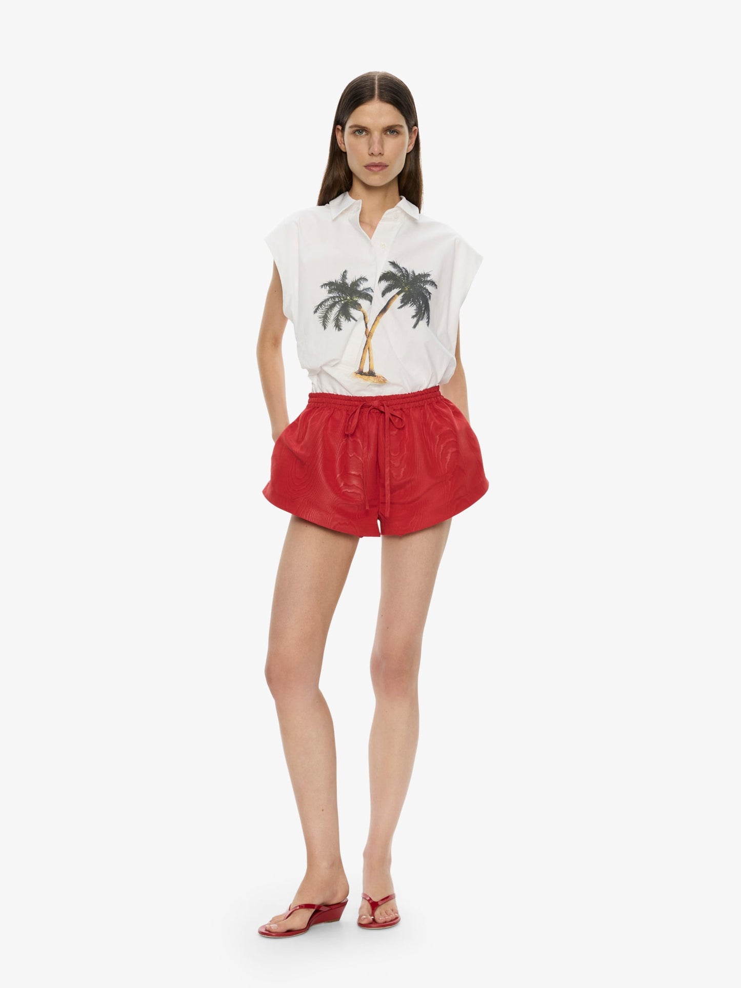 Image of a model wearing Shorts. Product name - Moire Archie Runner in Red colour by brand - CHRISTOPHER ESBER