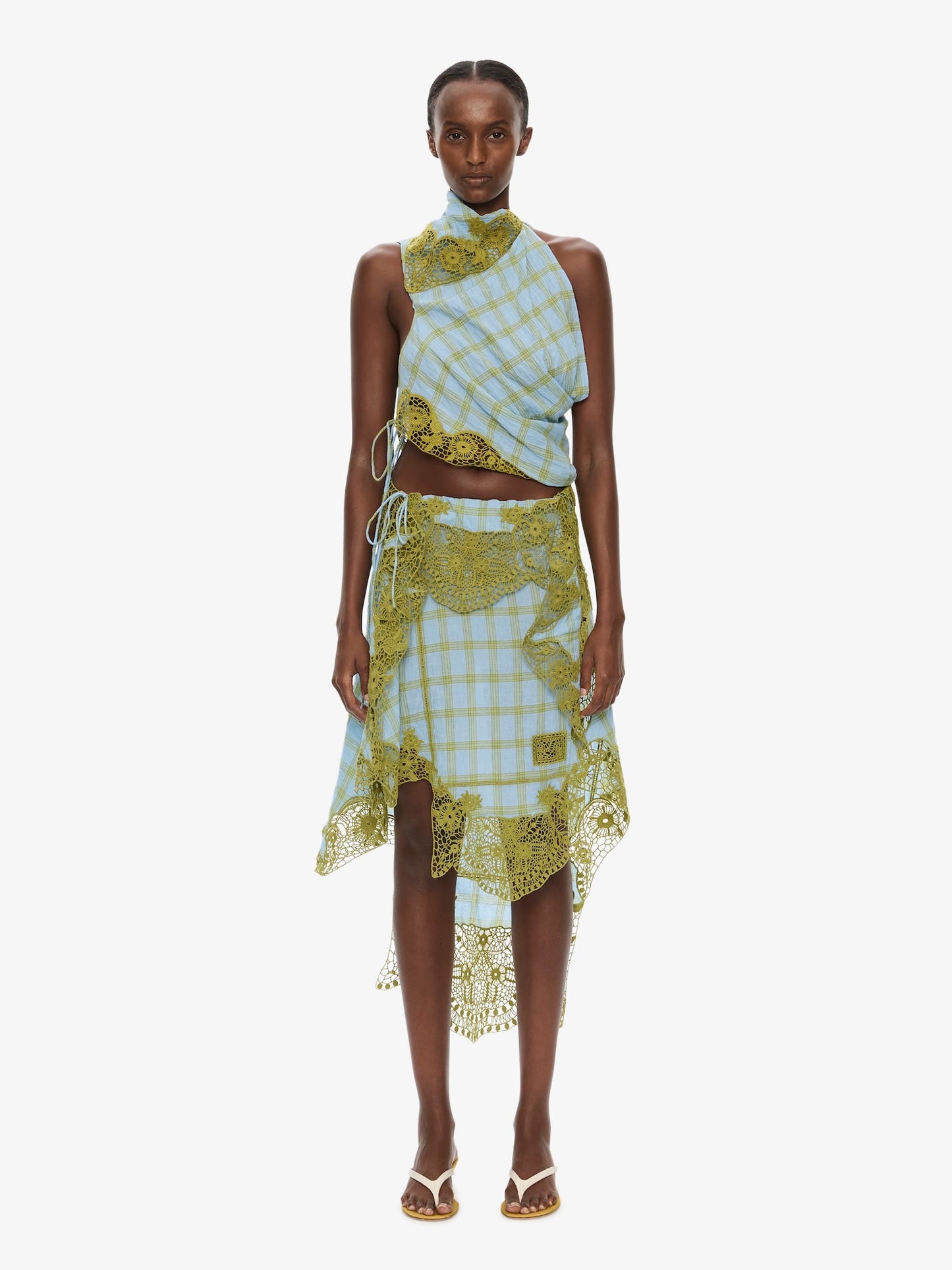 Image of a model wearing Skirts. Product name - Embroidered Handkerchief Envelope Midi Skirt in Check colour by brand - CHRISTOPHER ESBER