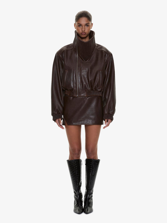 Image of a model wearing Skirts. Product name - Alfie Leather Mini Skirt in Brown colour by brand - CHRISTOPHER ESBER
