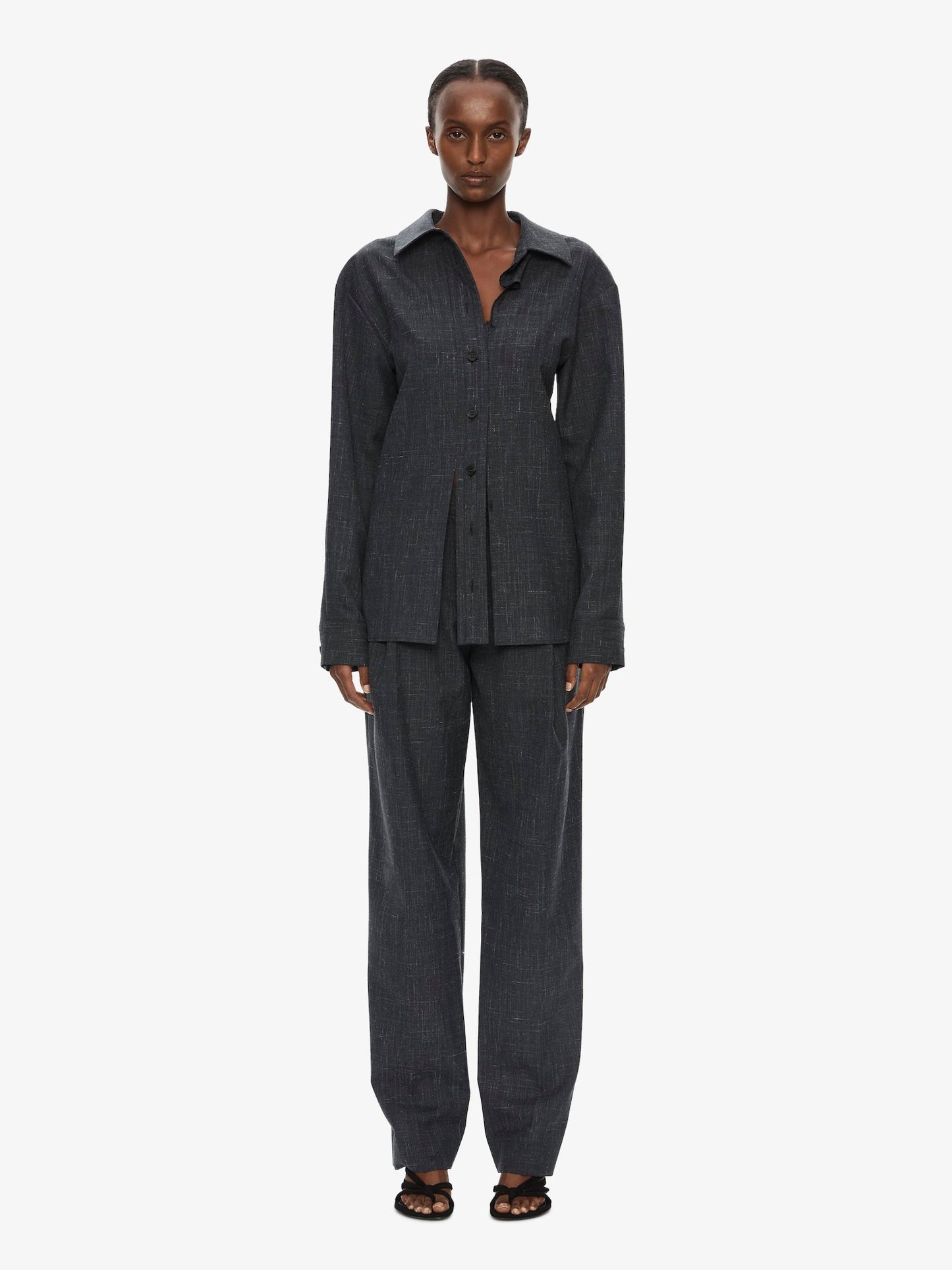 Image of a model wearing Pants. Product name - Banyan Tailored Trouser in Marle colour by brand - CHRISTOPHER ESBER
