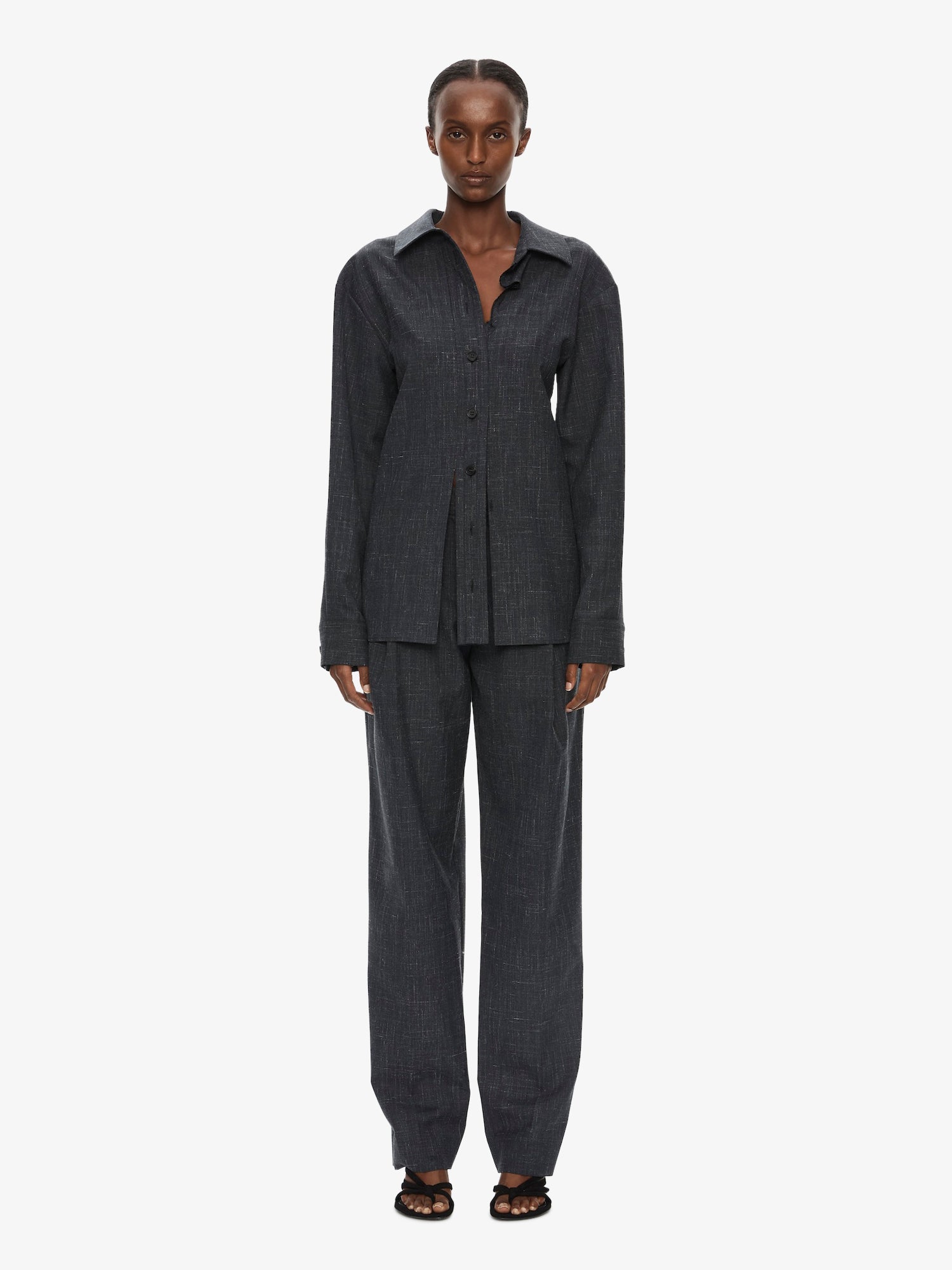 Image of a model wearing Pants. Product name - Banyan Tailored Trouser in Marle colour by brand - CHRISTOPHER ESBER