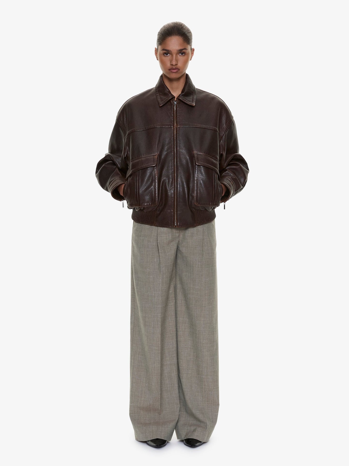 Image of a model wearing Pants. Product name - Tropical Wool Leather Waisted Trouser in Kombu colour by brand - CHRISTOPHER ESBER