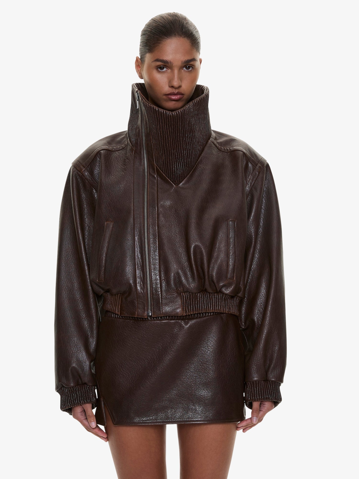 Image of a model wearing Outerwear. Product name - Lunnet Leather Bomber in Brown colour by brand - CHRISTOPHER ESBER