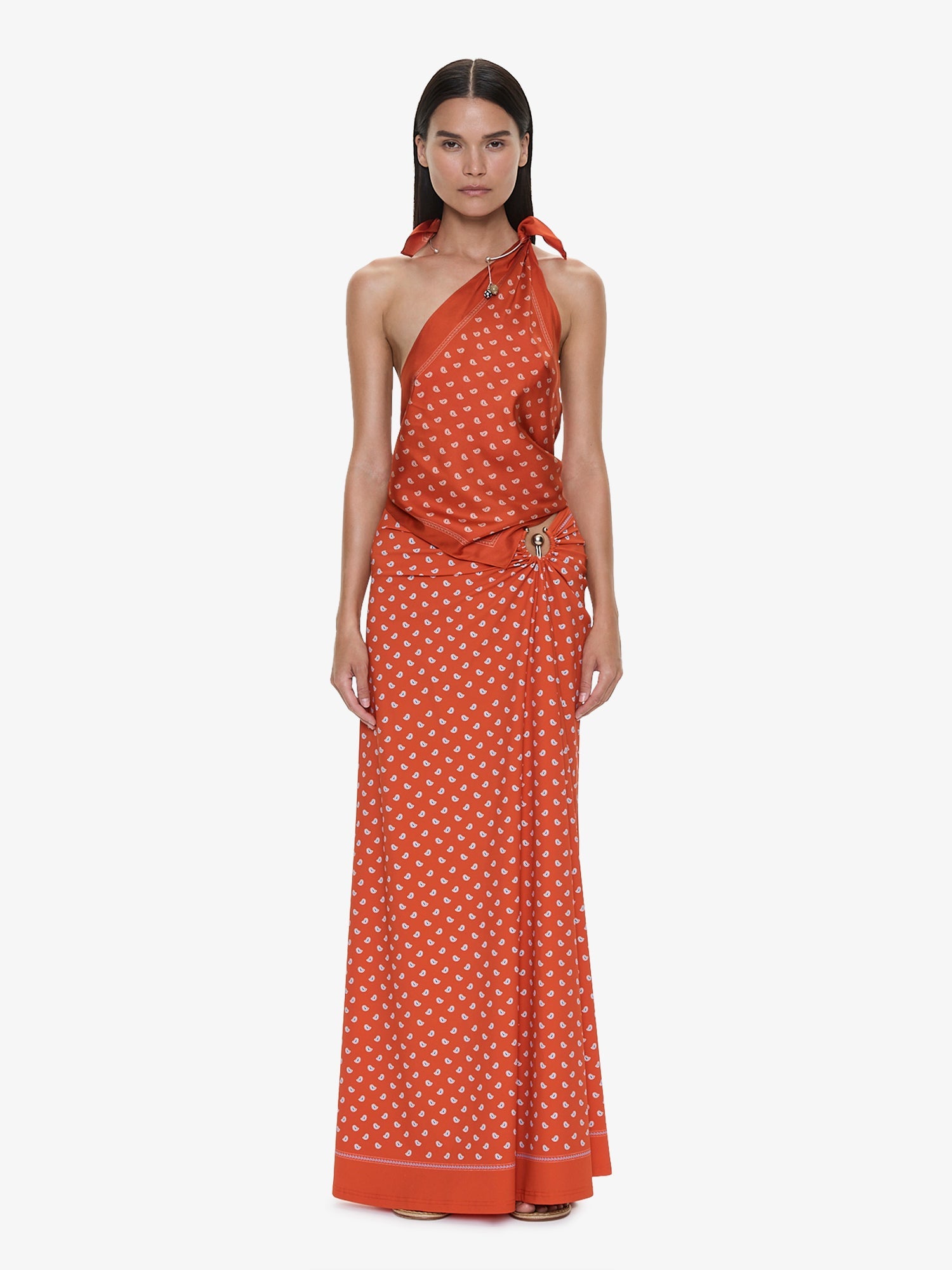 Image of a model wearing Skirts. Product name - Bandana Ruched Orbit Skirt in Carnelian colour by brand - CHRISTOPHER ESBER