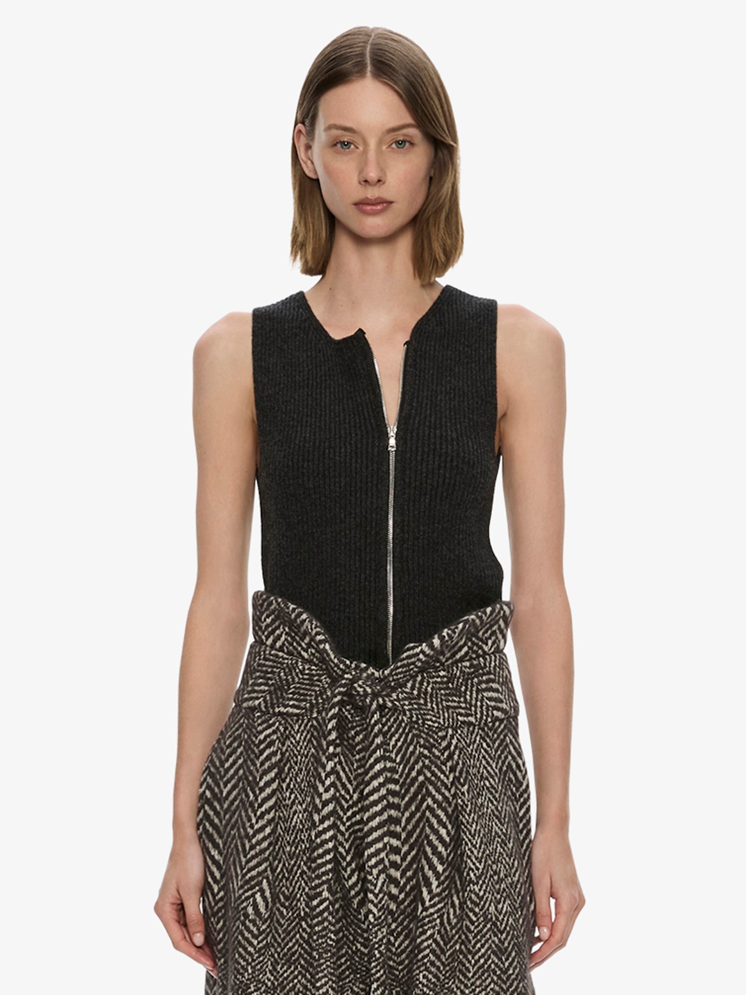 Image of a model wearing Tops. Product name - Isolde Zipped Tank in Charcoal colour by brand - CHRISTOPHER ESBER