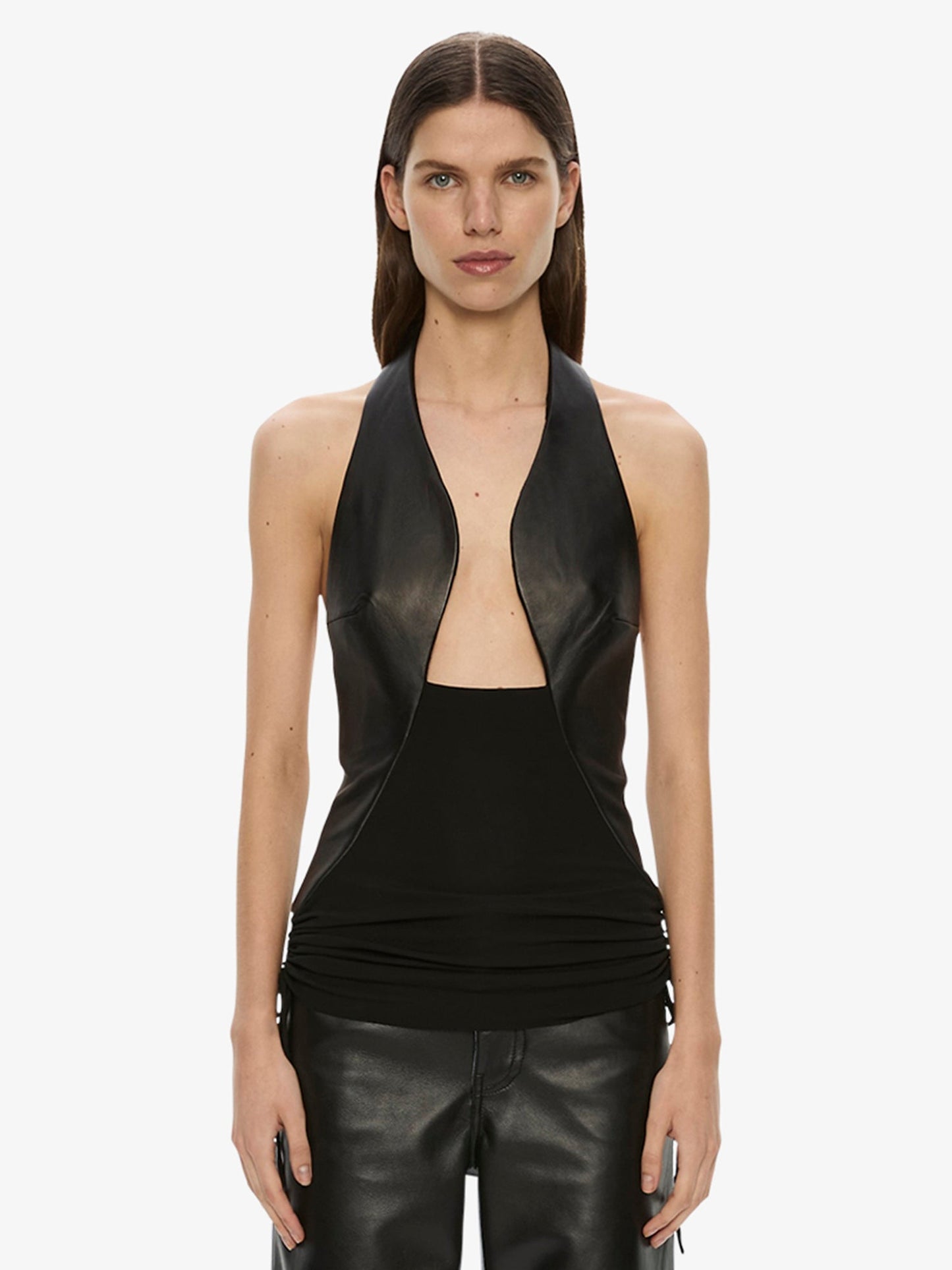 Image of a model wearing Tops. Product name - Tailored Slope Leather Halter Top in Black colour by brand - CHRISTOPHER ESBER