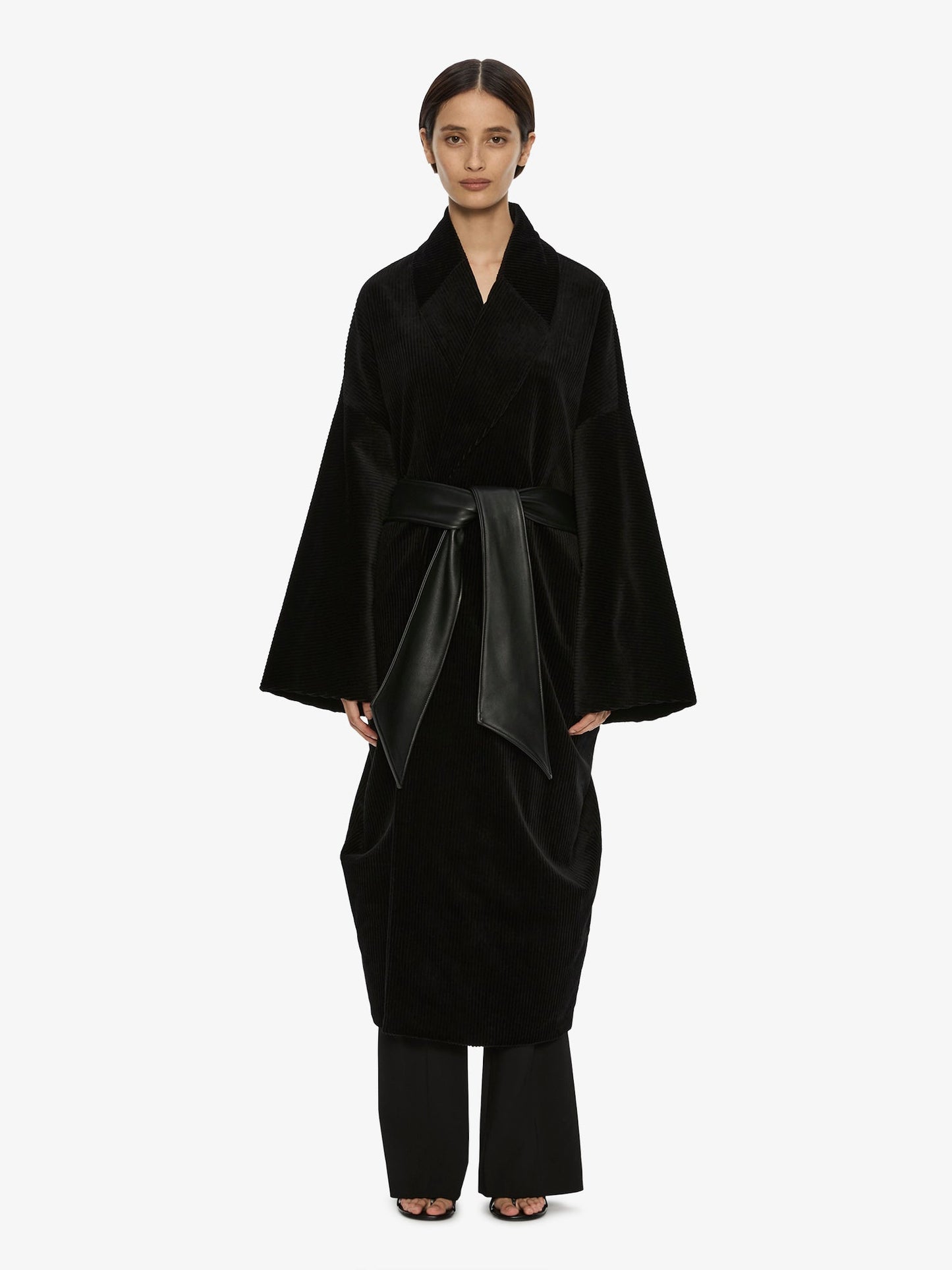 Image of a model wearing Outerwear. Product name - Manor Coat in Black colour by brand - CHRISTOPHER ESBER