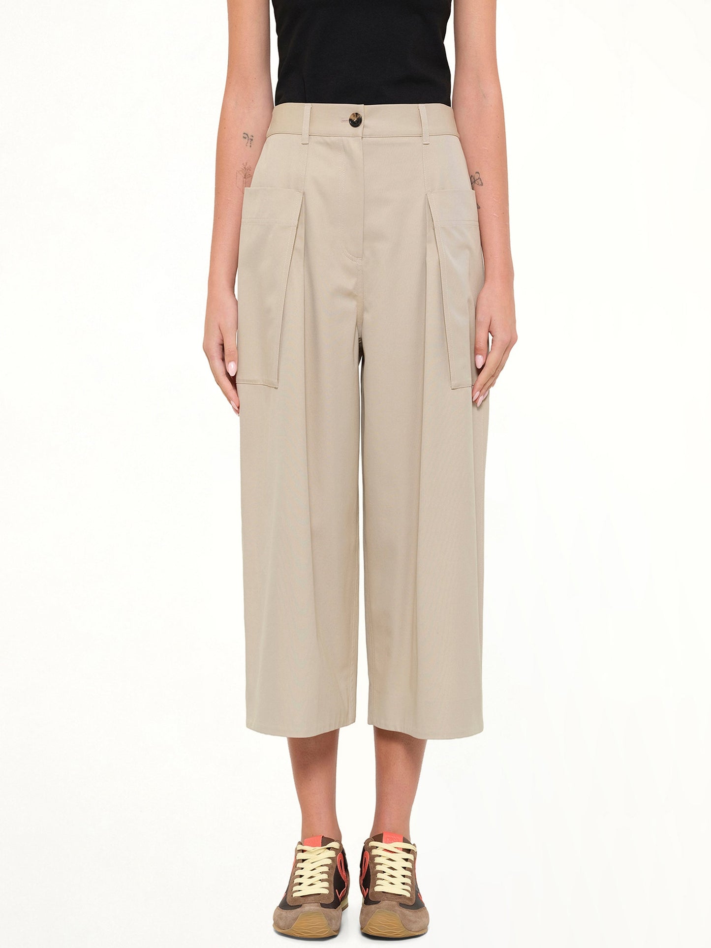 Image of a model wearing Pants. Product name - Cropped Trousers in Beige colour by brand - LOEWE