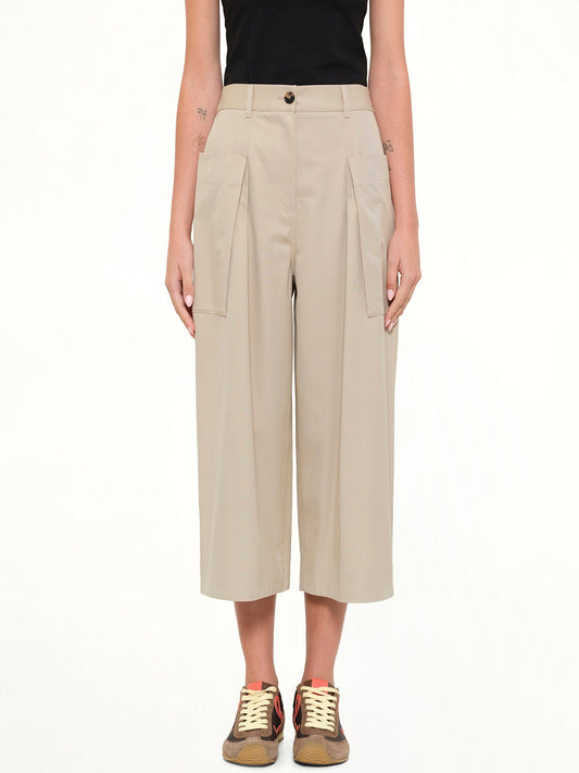Image of a model wearing Pants. Product name - Cropped Trousers in Beige colour by brand - LOEWE
