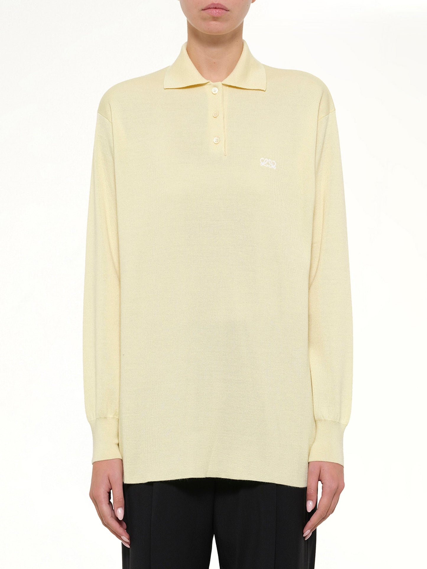 Image of a model wearing Tops. Product name - Polo Sweater in Yellow colour by brand - LOEWE