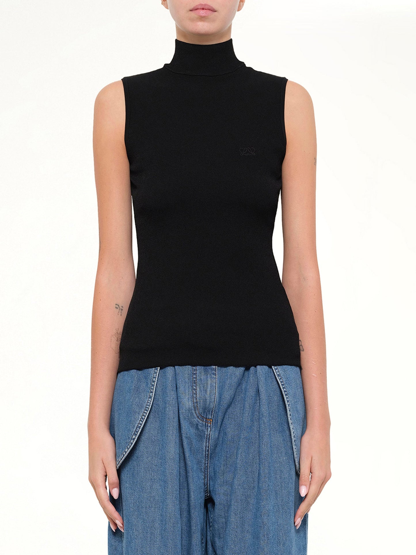 Image of a model wearing Tops. Product name - Sleeveless Top in Black colour by brand - LOEWE