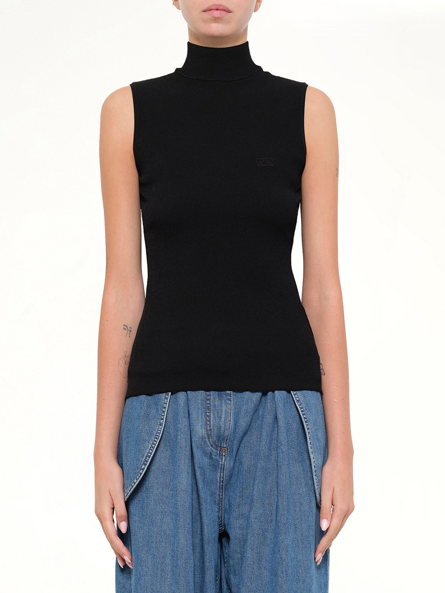 Image of a model wearing Tops. Product name - Sleeveless Top in Black colour by brand - LOEWE