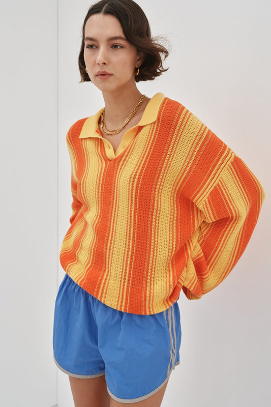 Image of a model wearing Tops. Product name - Odette Sweater Preorder in Tangerine colour by brand - Blanca Studio