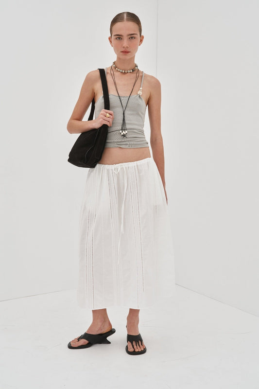 Image of a model wearing Skirts. Product name - Alba Skirt Preorder in White colour by brand - Blanca Studio