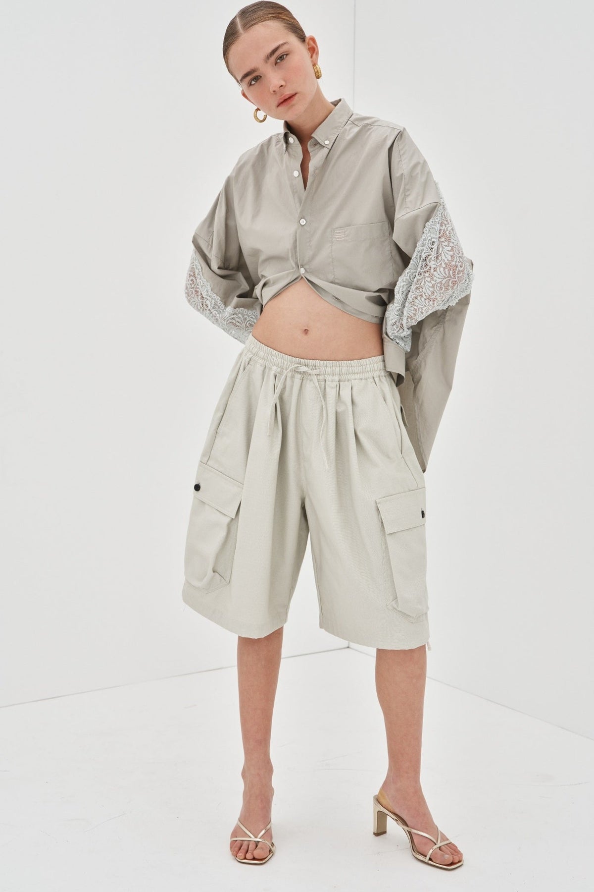 Image of a model wearing Shorts. Product name - Blaise Shorts Preorder in Grey colour by brand - Blanca Studio