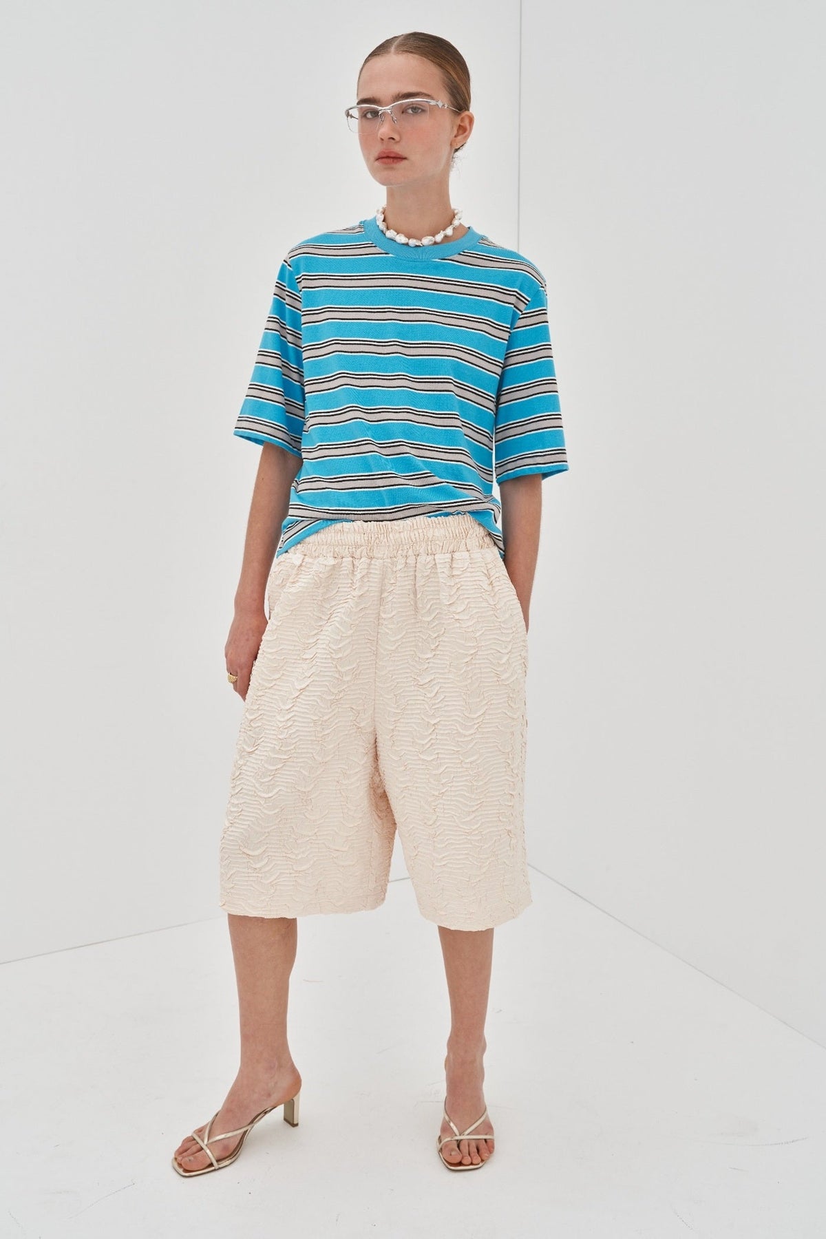 Image of a model wearing Tops. Product name - Celeste Tee Preorder in Turquoise colour by brand - Blanca Studio
