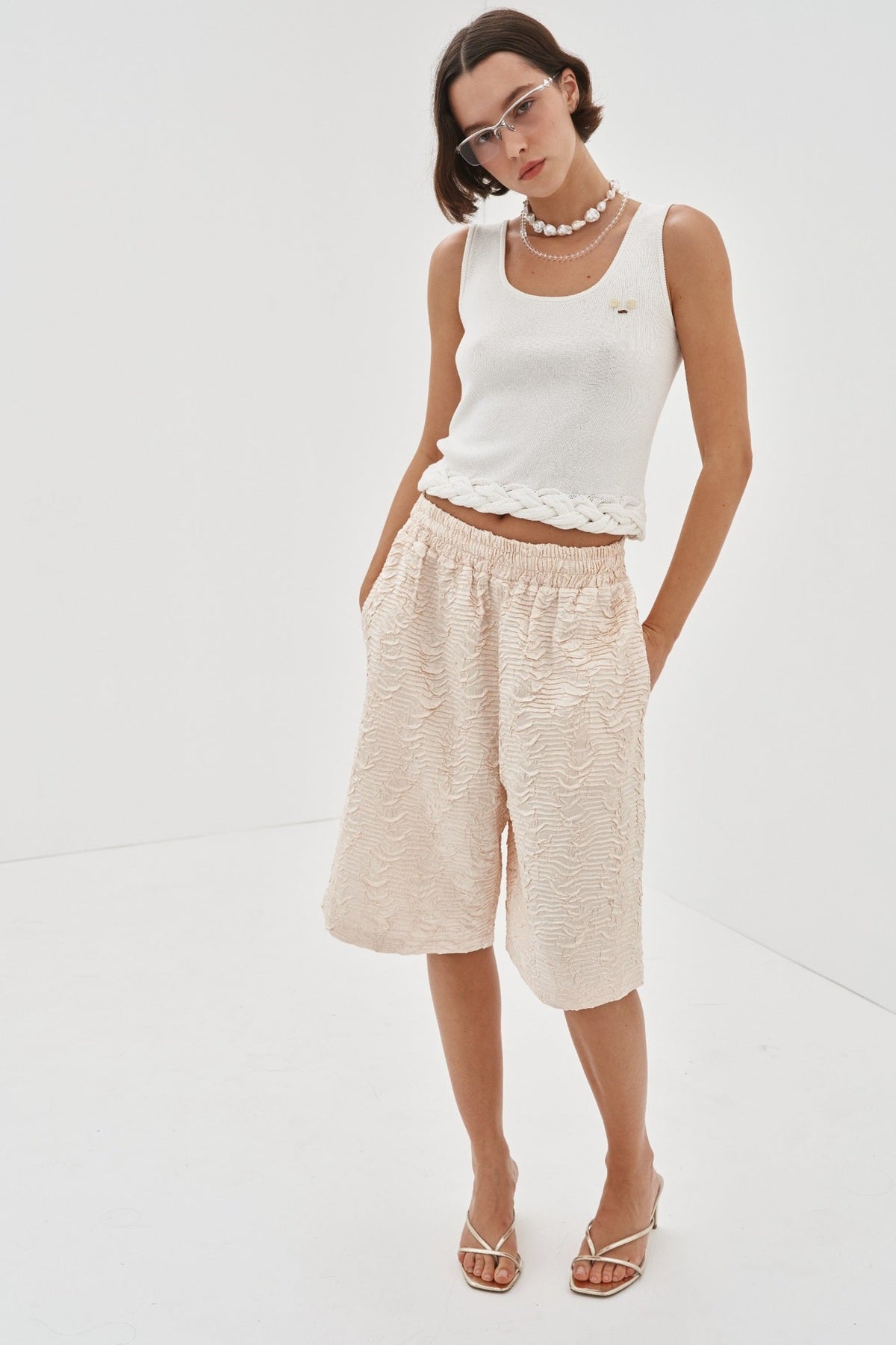 Image of a model wearing Shorts. Product name - Ines Shorts Preorder in Cream colour by brand - Blanca Studio