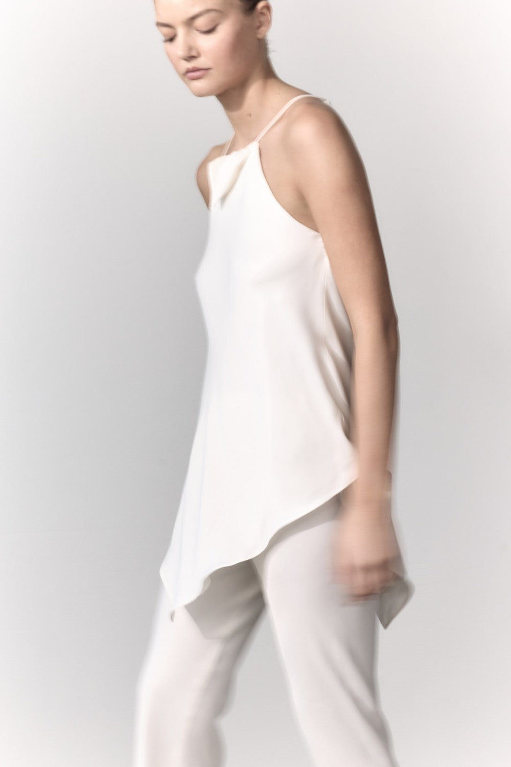 Image of a model wearing Tops. Product name - Oblique Racer Top in White colour by brand - MANNING CARTELL