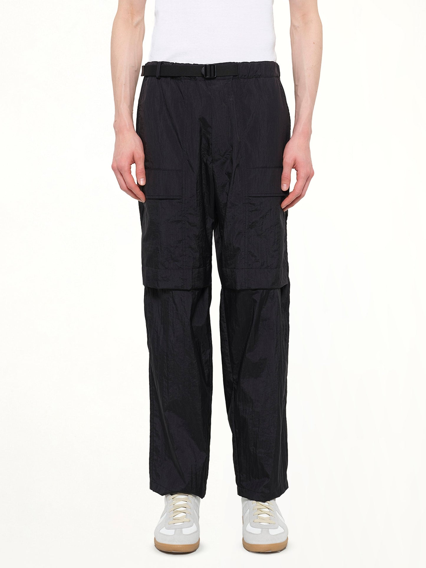 Image of a model wearing Pants. Product name - Detachable Zip Pant in Black colour by brand - JUUNJ