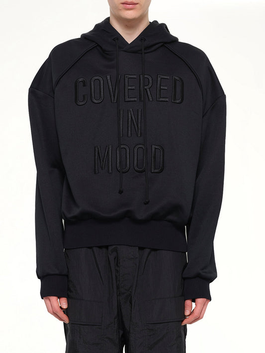 Image of a model wearing Outerwear. Product name - JuunJ Mood Hoodie in Black colour by brand - JUUNJ