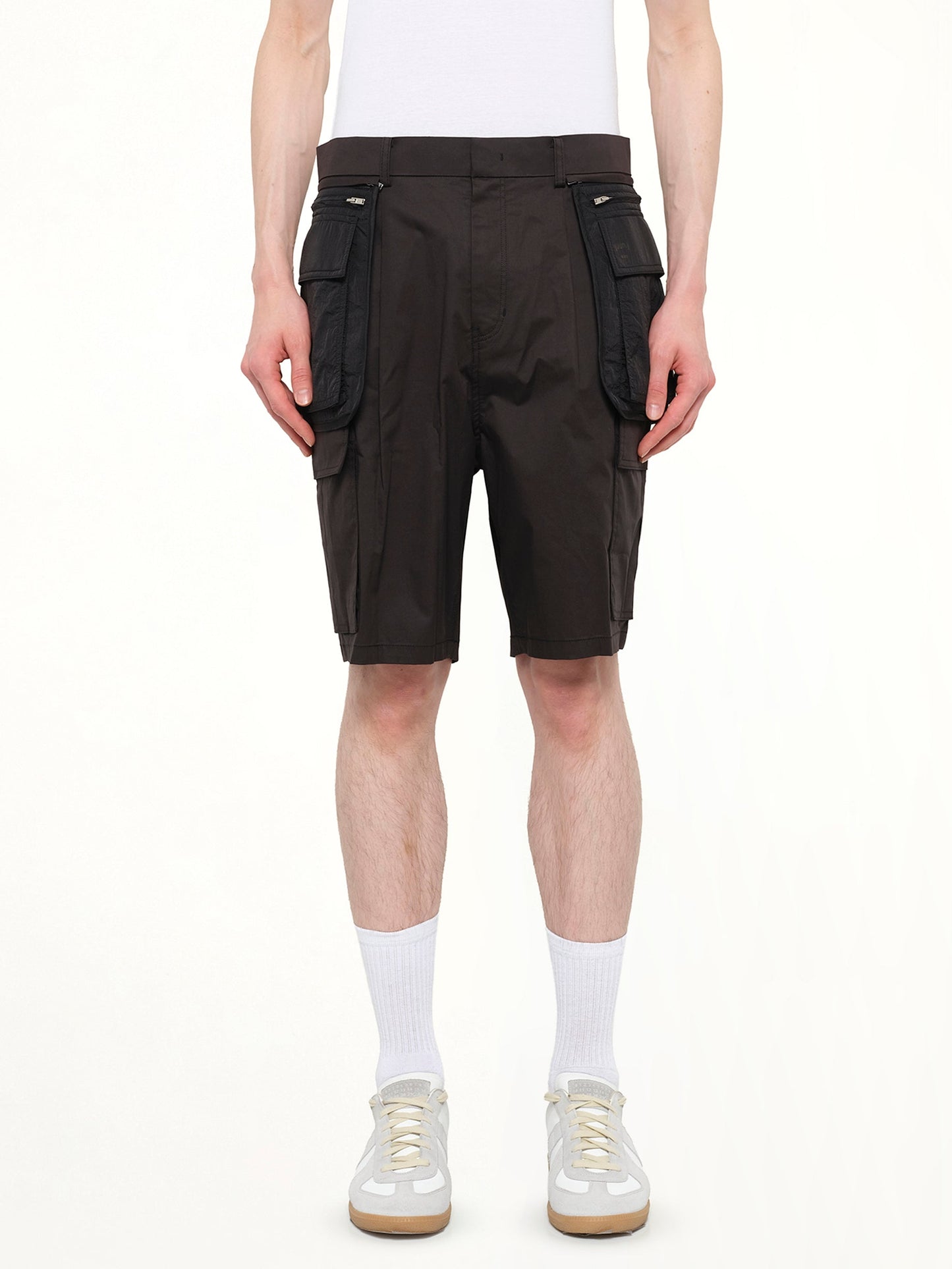 Image of a model wearing Shorts. Product name - Juunj Cargo Shorts in Black colour by brand - JUUNJ
