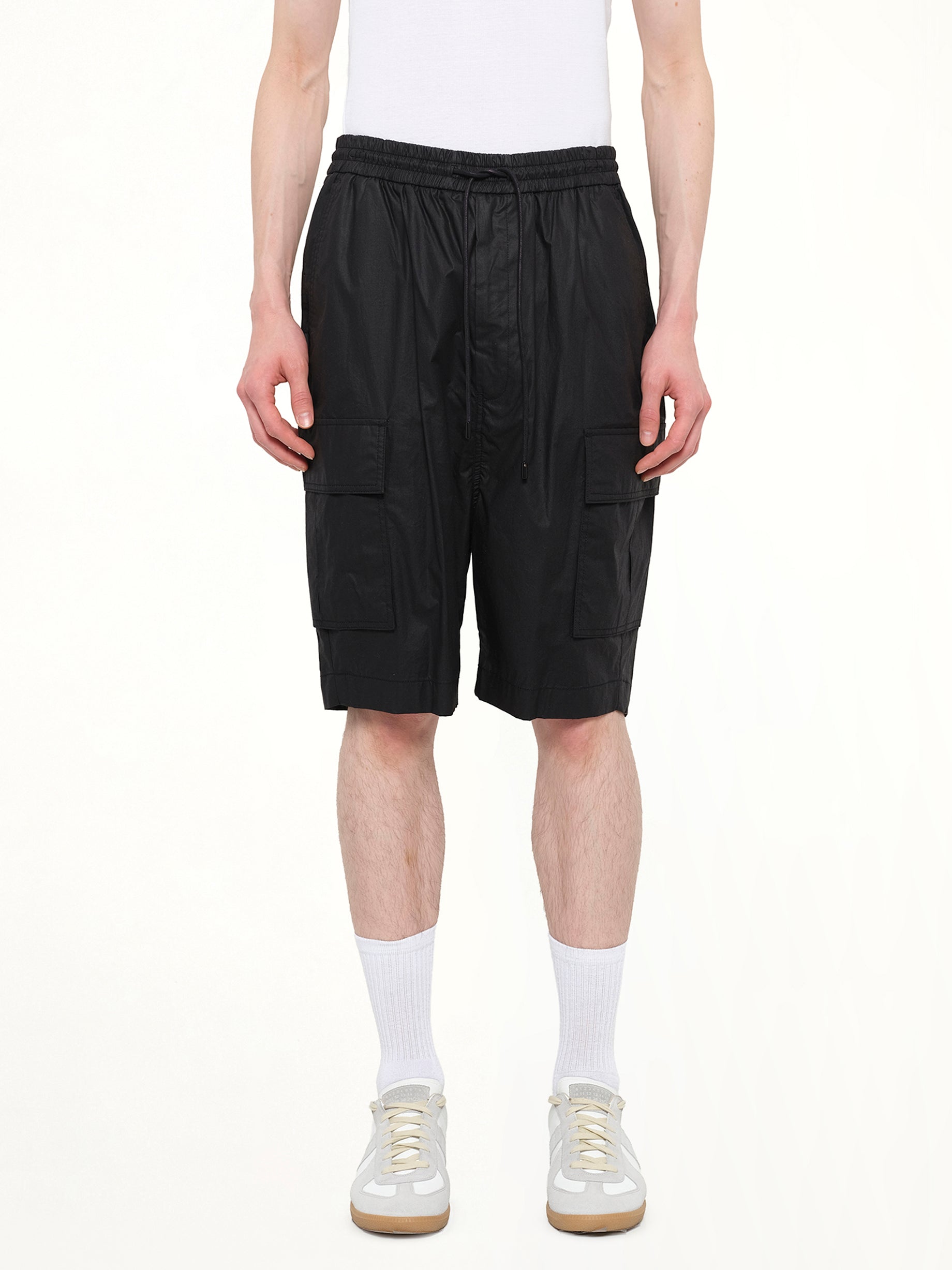 Image of a model wearing Shorts. Product name - Juunj Short in Black colour by brand - JUUNJ
