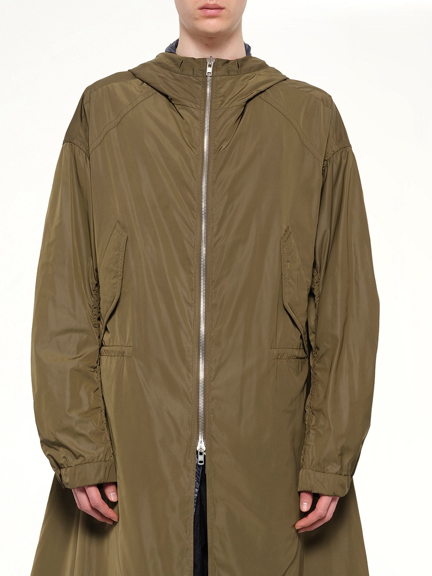 Image of a model wearing Outerwear. Product name - Parka in Khaki colour by brand - JUUNJ