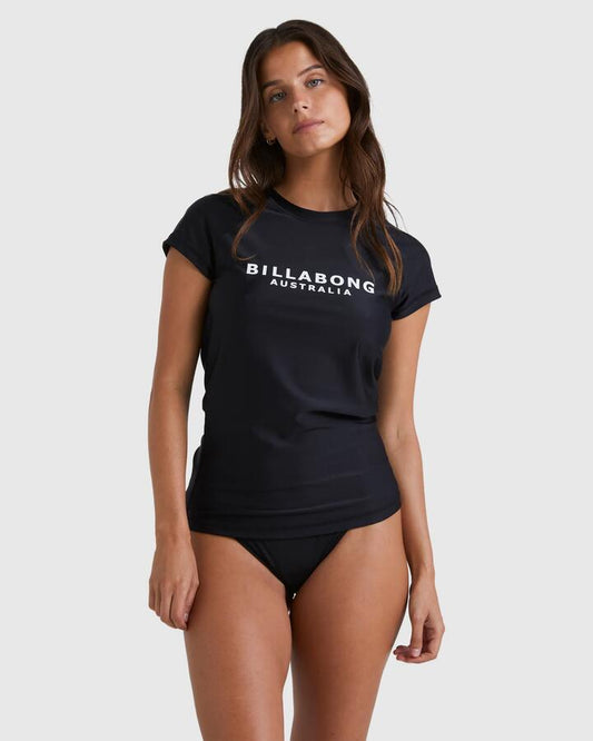 Image of a model wearing Tops. Product name - Billabong Womens Society Short Sleeve Rash Vest Black in Black colour by brand - Billabong