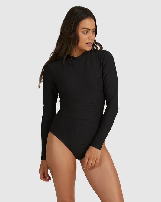 Image of a model wearing Tops. Productname: Billabong - Womens Tanlines Bodysuit Rash Vest - Black - in Black colour by brand - Billabong