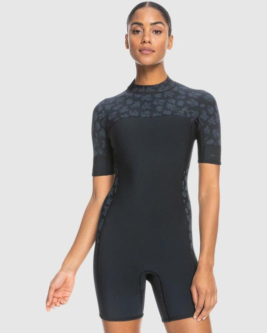 Image of a model wearing Tops. Productname: Roxy - Womens 2Mm Swell Series Back Zip Short Sleeve Springsuit - Black - in Black colour by brand - Roxy